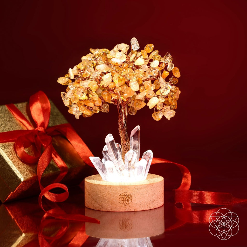 Golden Lamp of Wealth - Citrine Tree next to a wrapped present with red ribbons.