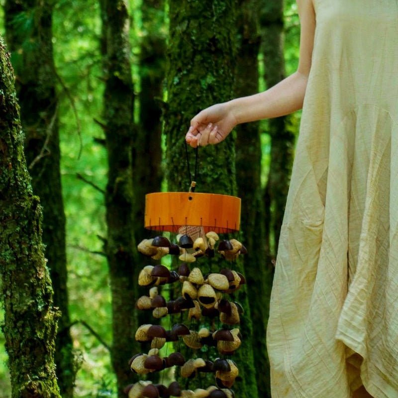 Picture of a person holding a seed pod wind chime.