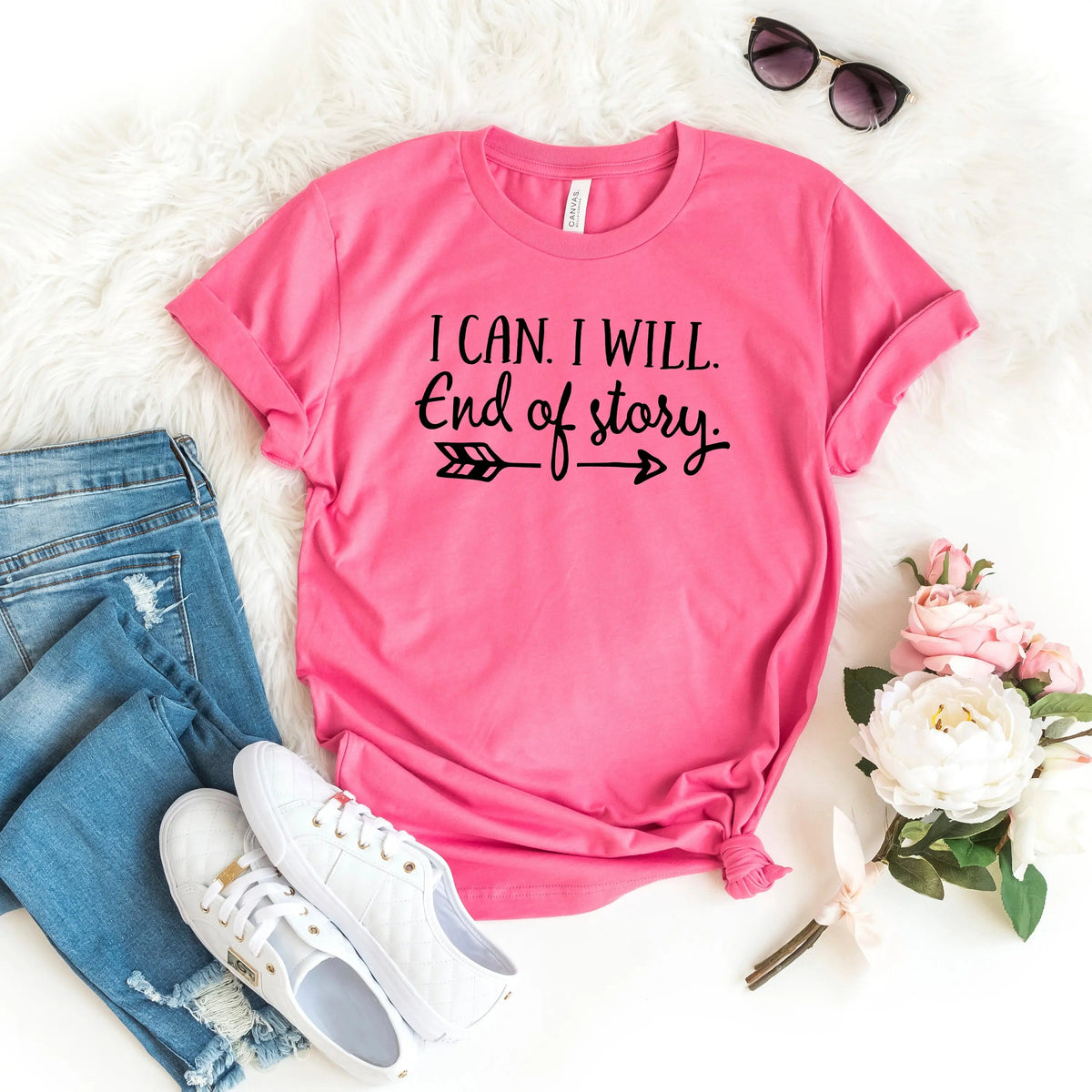 A bright pink graphic t-shirt with the text 'I CAN. I WILL.