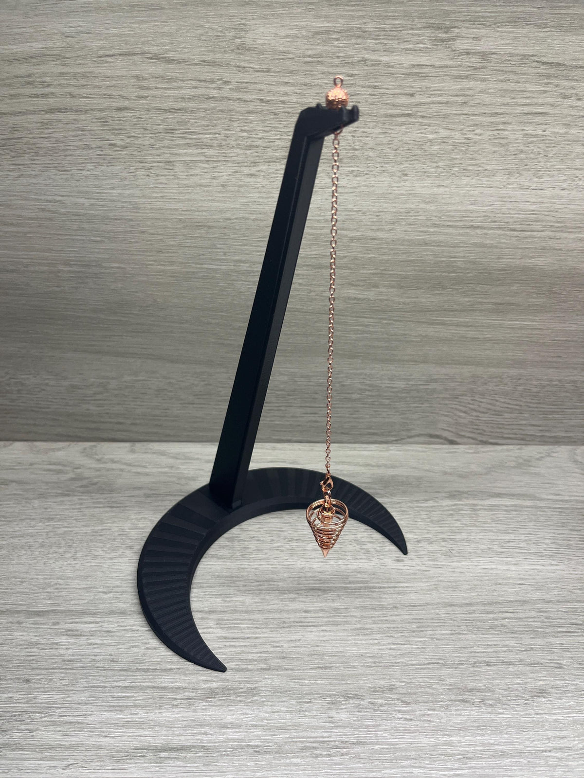 A Large Black Pendulum Moon Stand