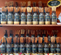 Two shelved full of jars of incense sticks.