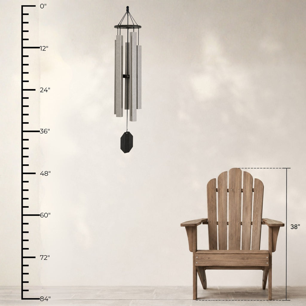 Wooden Adirondack chair with a wind chime and measurement chart on a light background