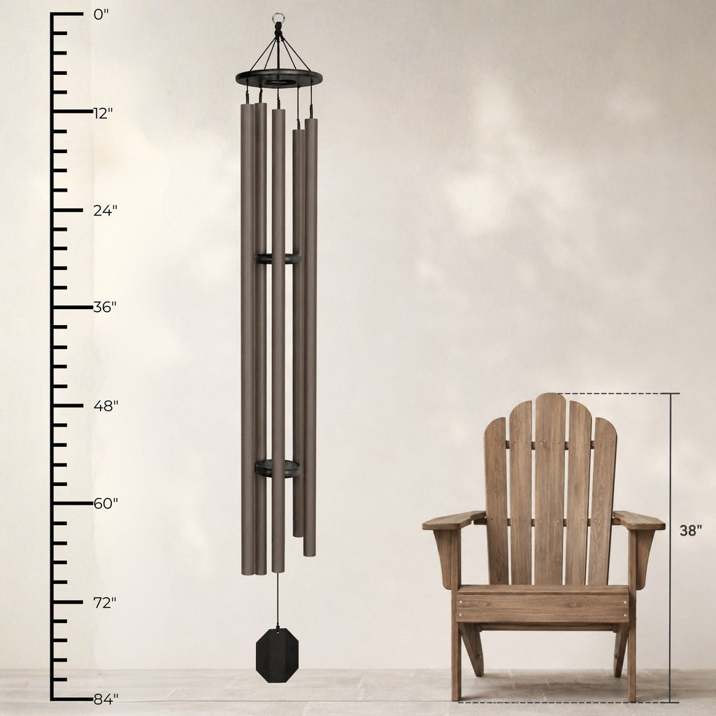 Wind chime next to a wooden chair with measurements on a plain background