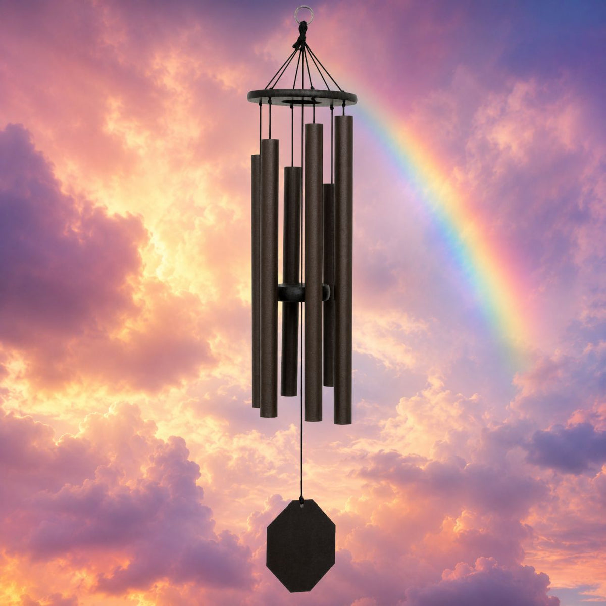 Black wind chime against a colorful sky with a rainbow