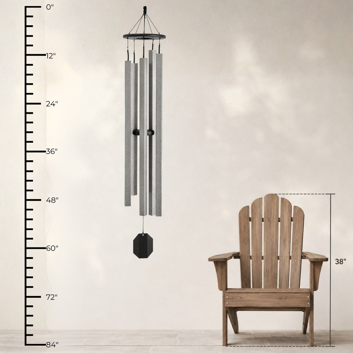 Wind chime next to a wooden Adirondack chair with measurement scale on a light background