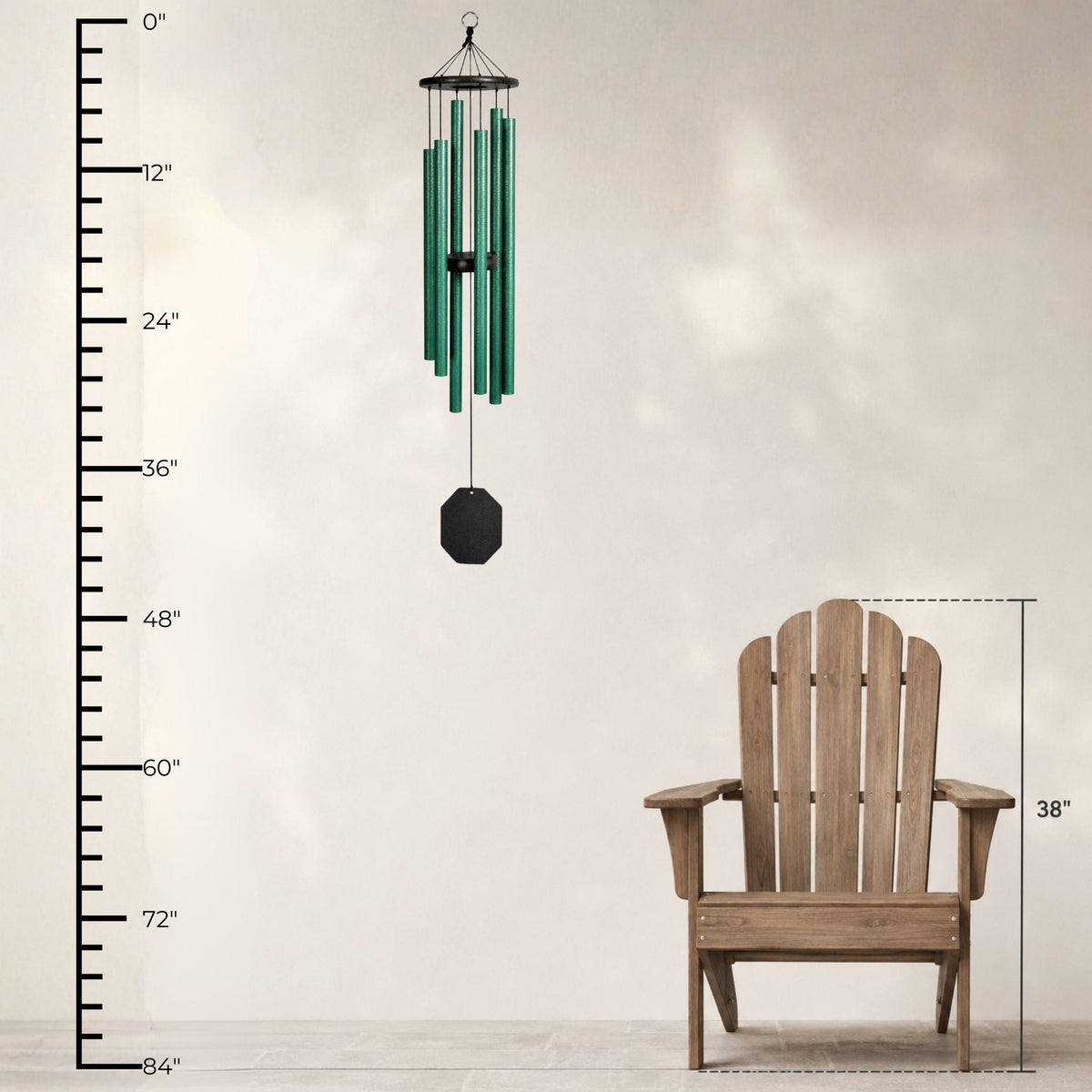Green wind chime next to a wooden Adirondack chair with measurements on a plain background