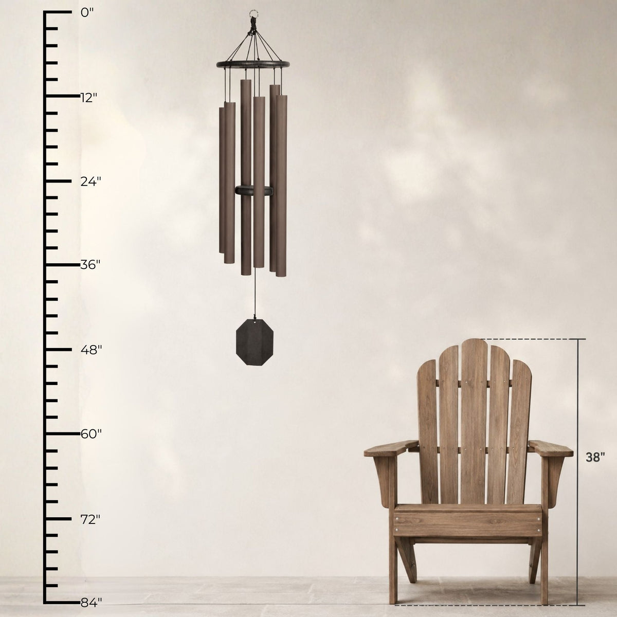 Wooden Adirondack chair and wind chime with measurement scale on a light background