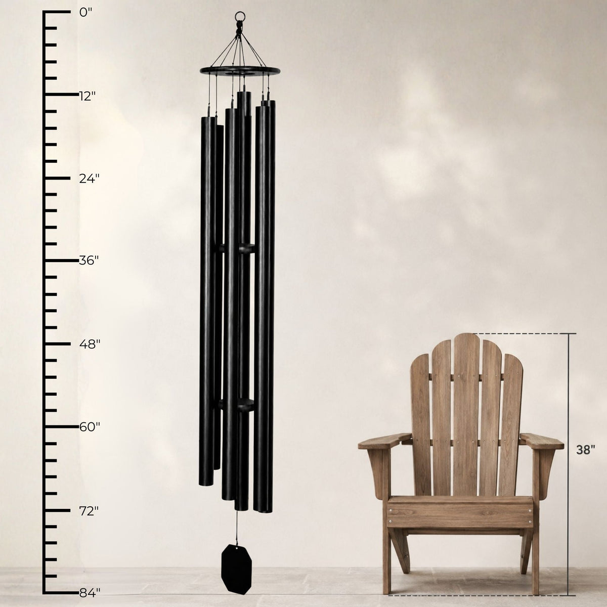 Black wind chime next to a wooden chair with measurement indicators on a light gray background