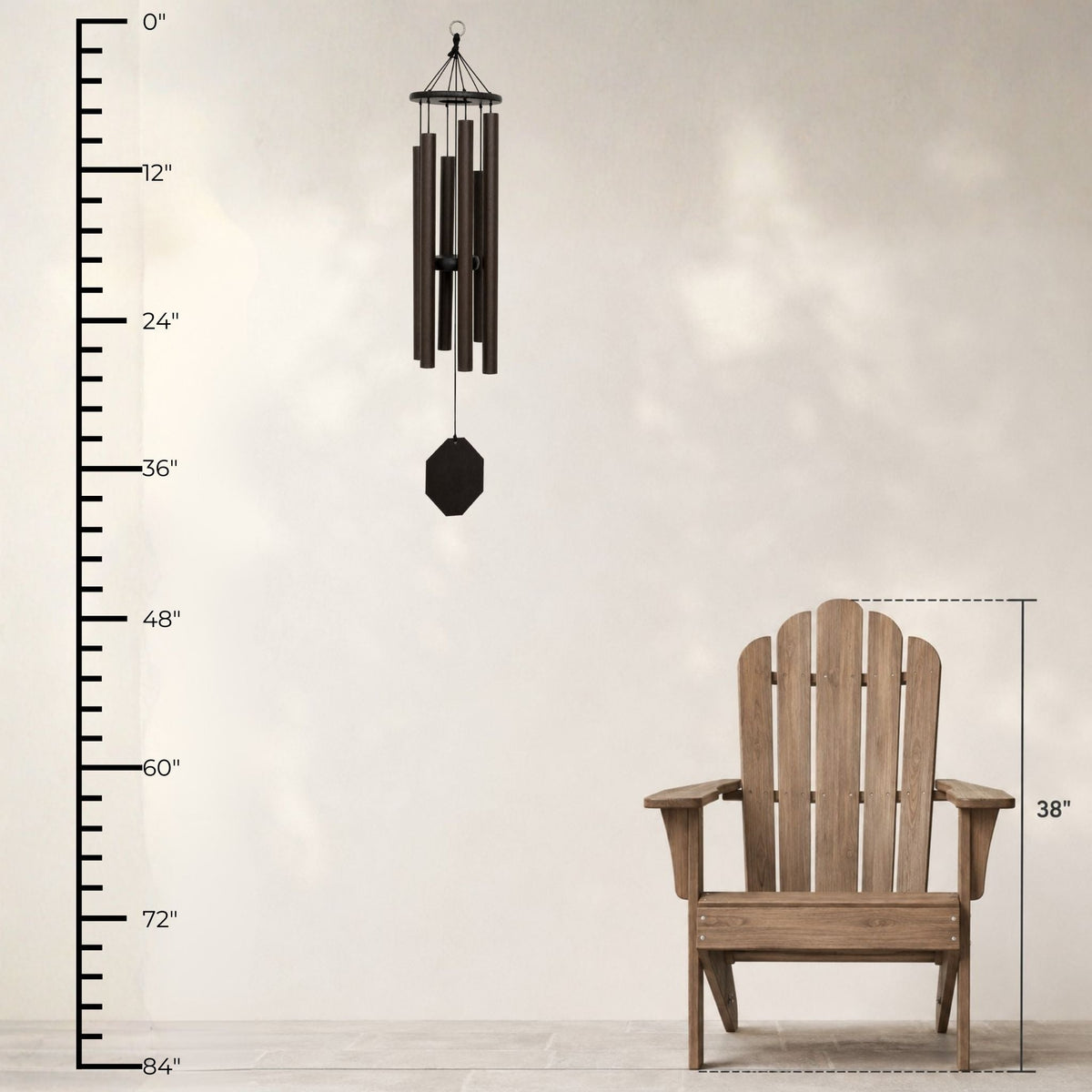 Wooden Adirondack chair with a wind chime and measurement chart on a light background