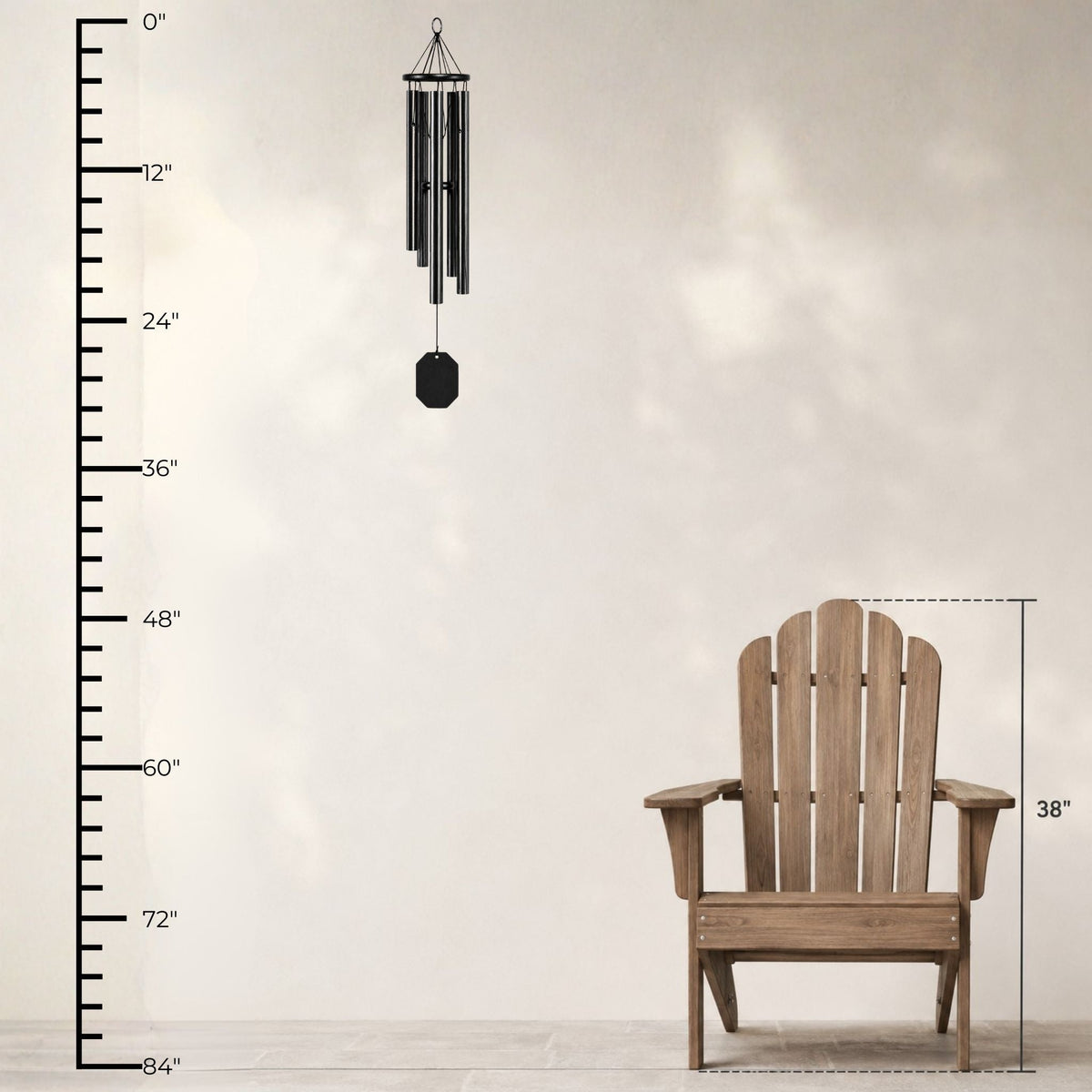 Wooden Adirondack chair with a wind chime and measurement chart on a light background