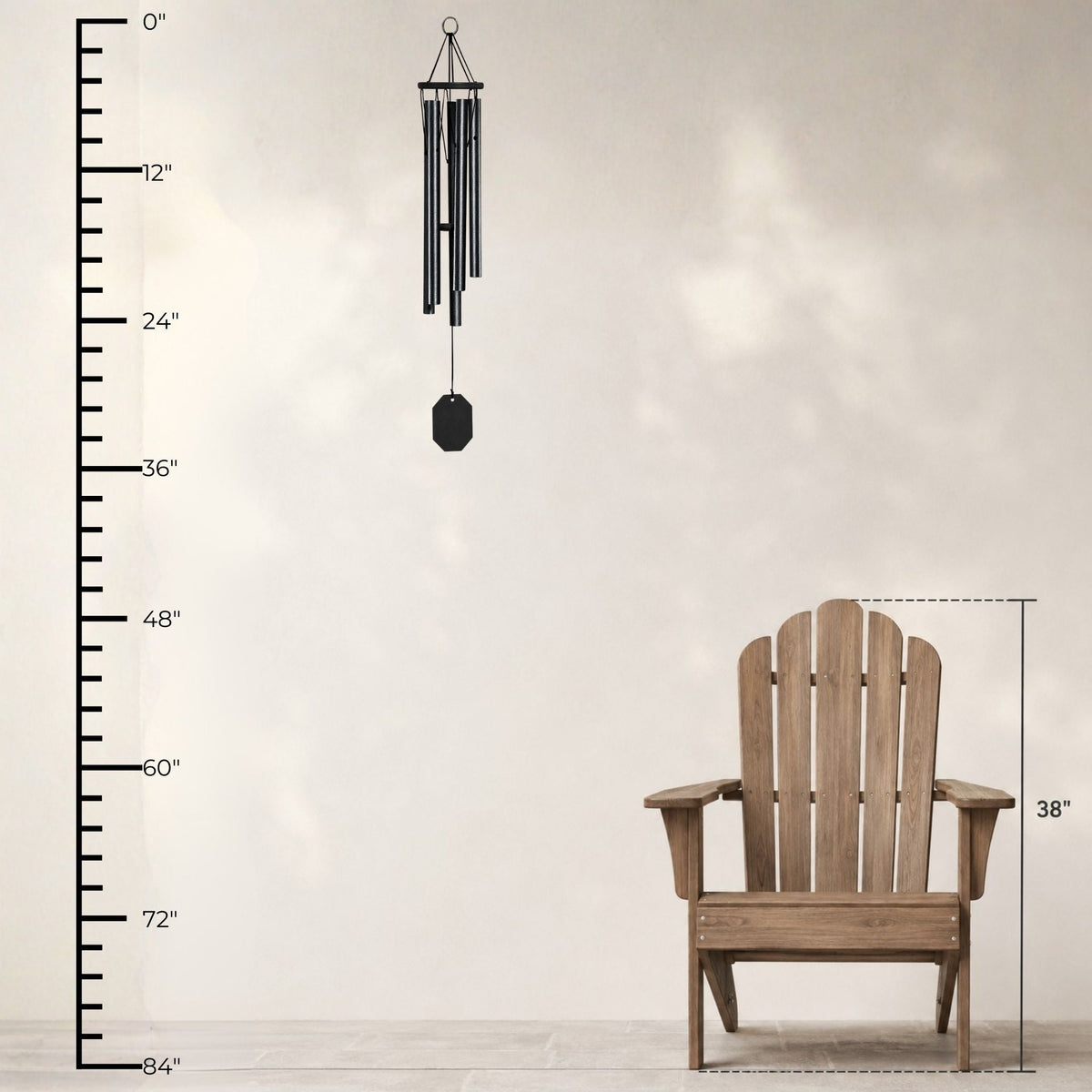 Wooden Adirondack chair with a wind chime and measurement chart on a light background