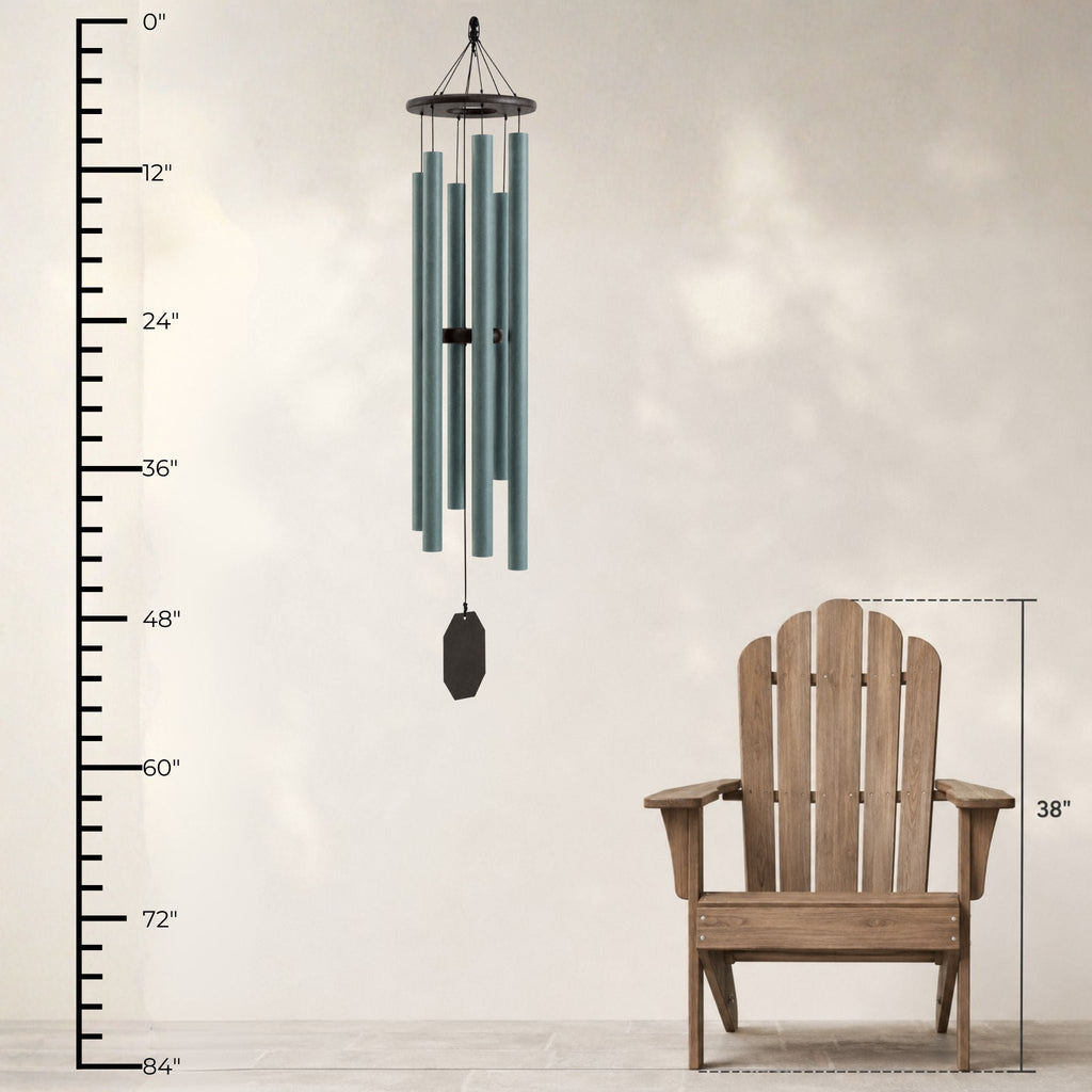 Wind chime next to a wooden Adirondack chair with measurements on a plain background