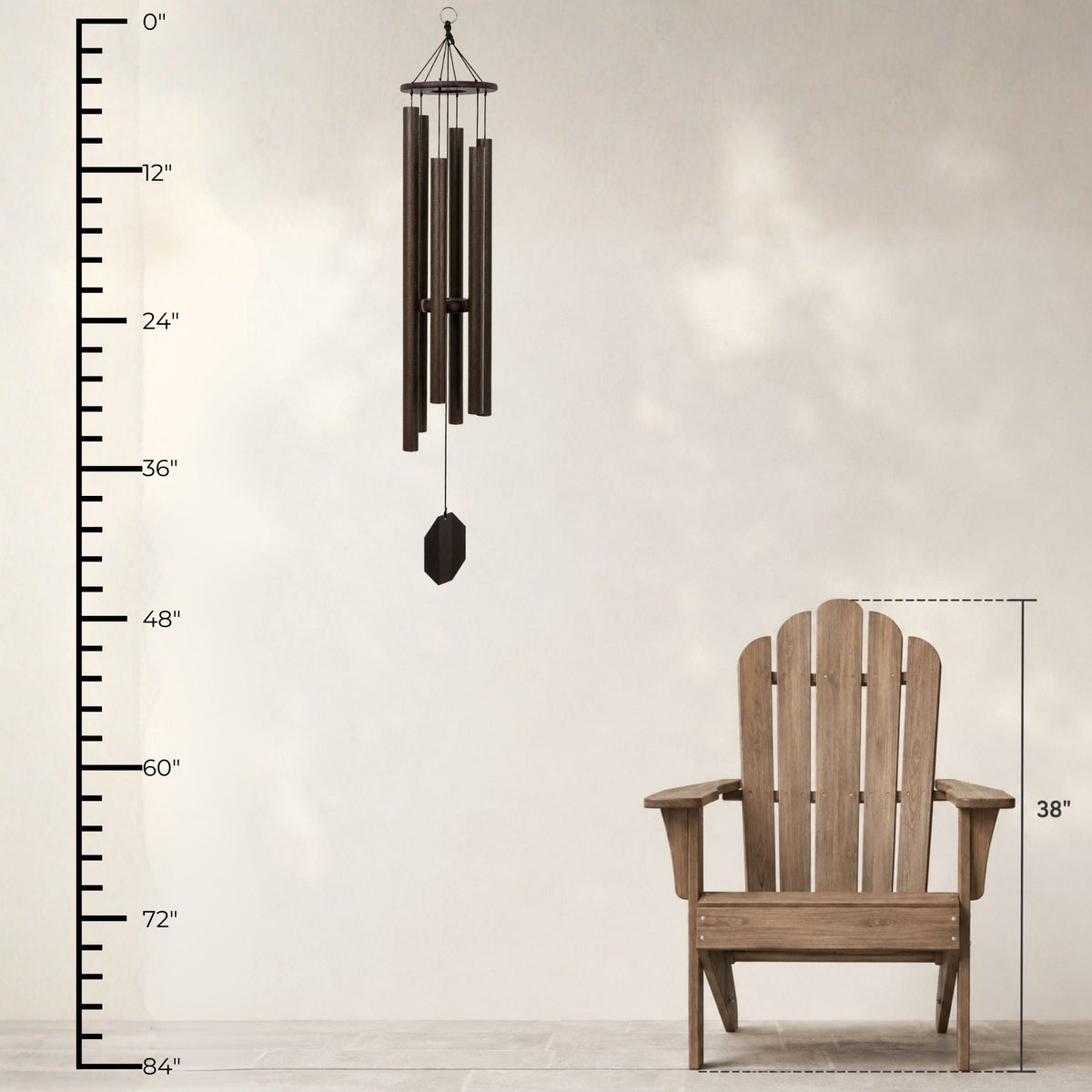 Wooden Adirondack chair and wind chime with measurement scale on a plain background