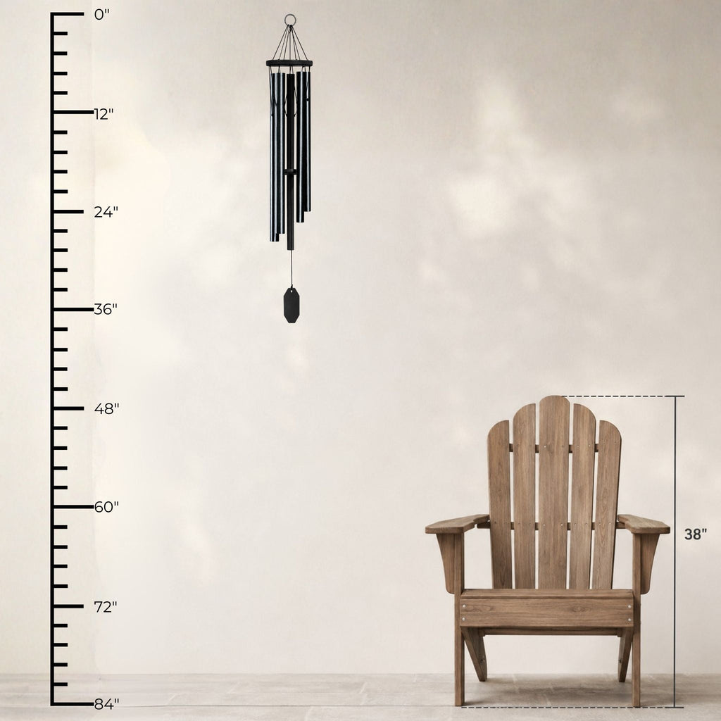 Wooden Adirondack chair with a wind chime and measurement chart on a light background