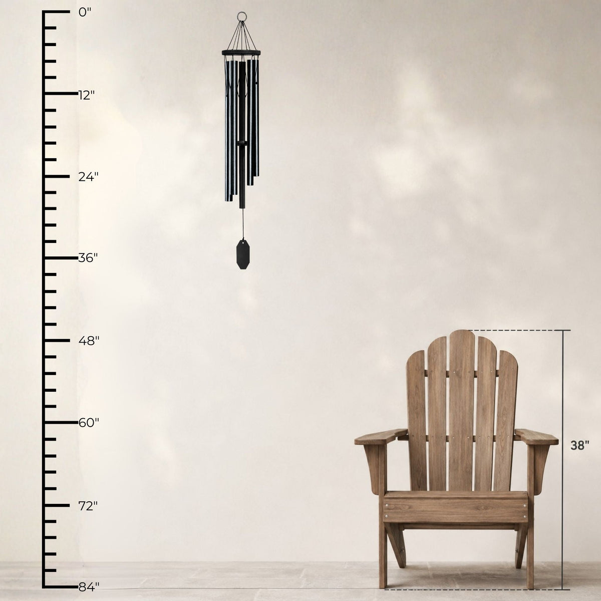 Wooden Adirondack chair with a wind chime and measurement chart on a light background