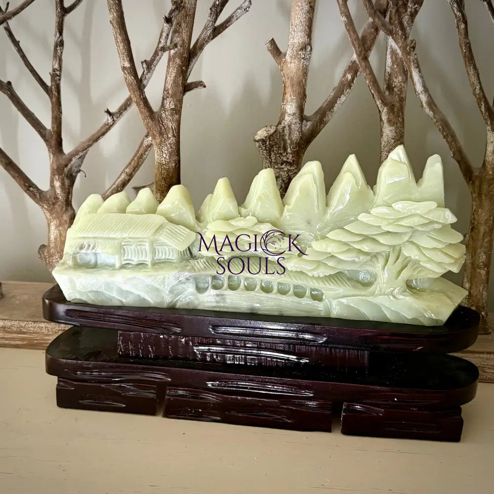 Decorative sculpture with 'Magick Souls' branding on a wooden base.