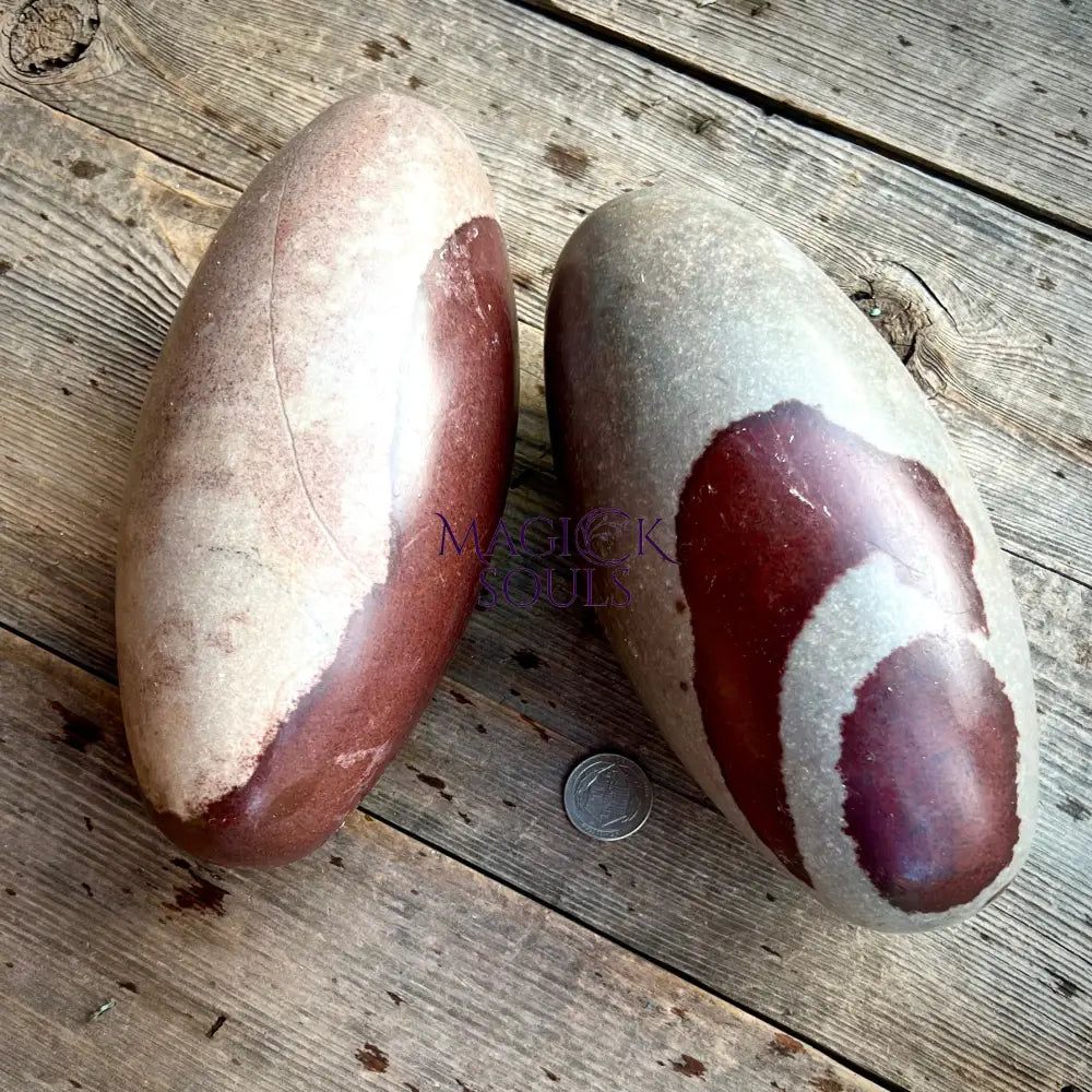 Two large stones with a coin for scale on a wooden surface, branded 'Mystic Souls'.
