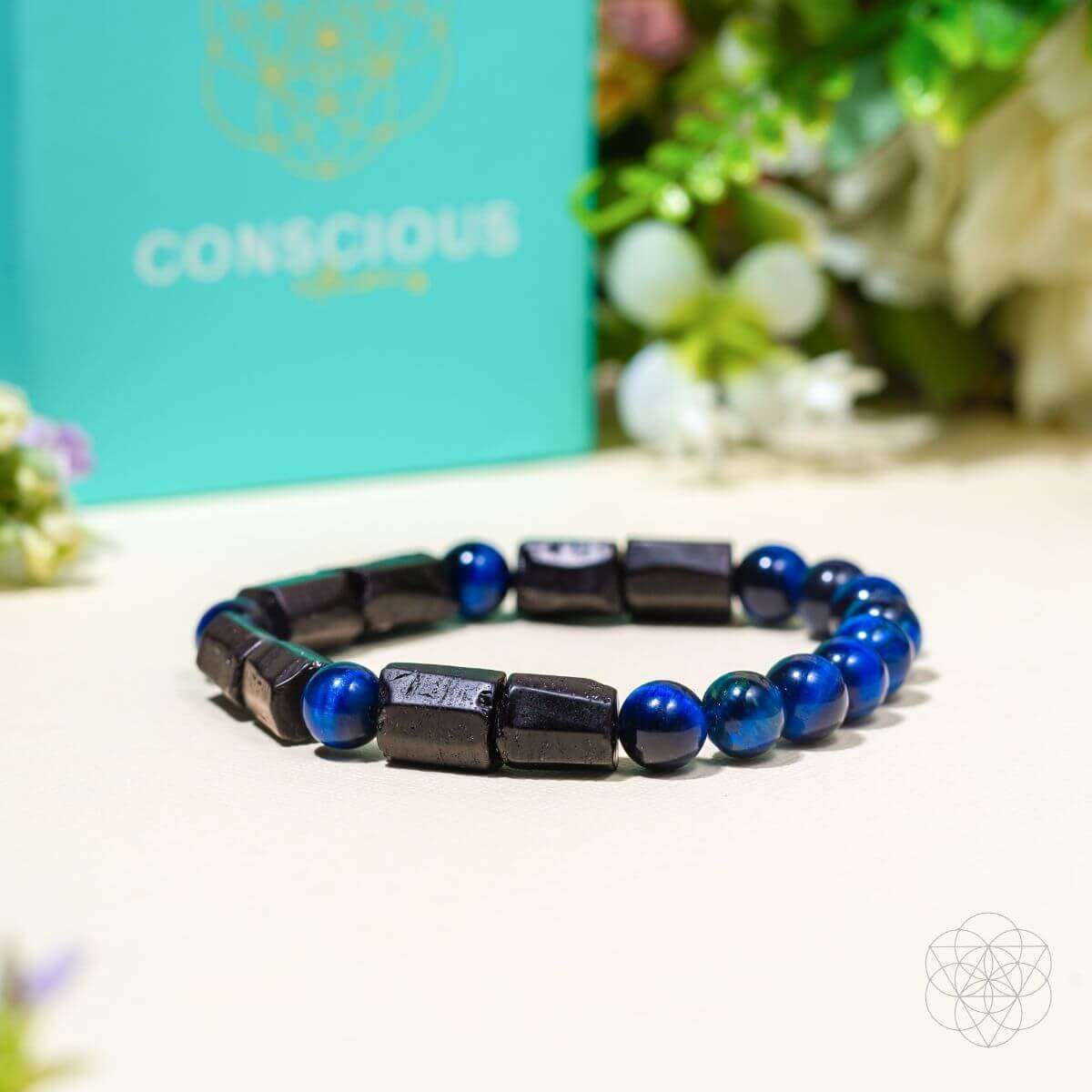 An Aura Protection Bracelet laying on a tan surface