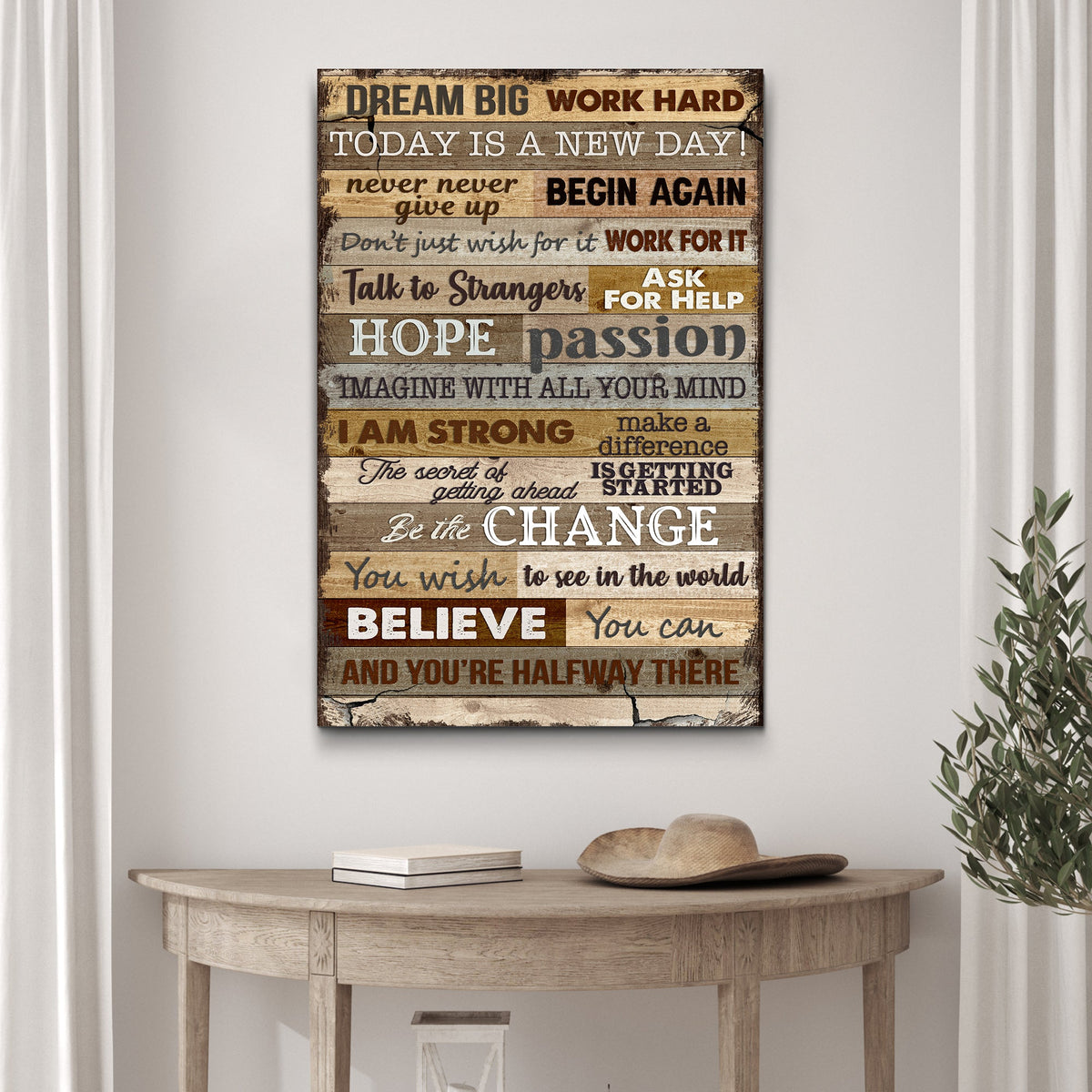 Motivational poster with inspirational quotes on a wall above a wooden table.