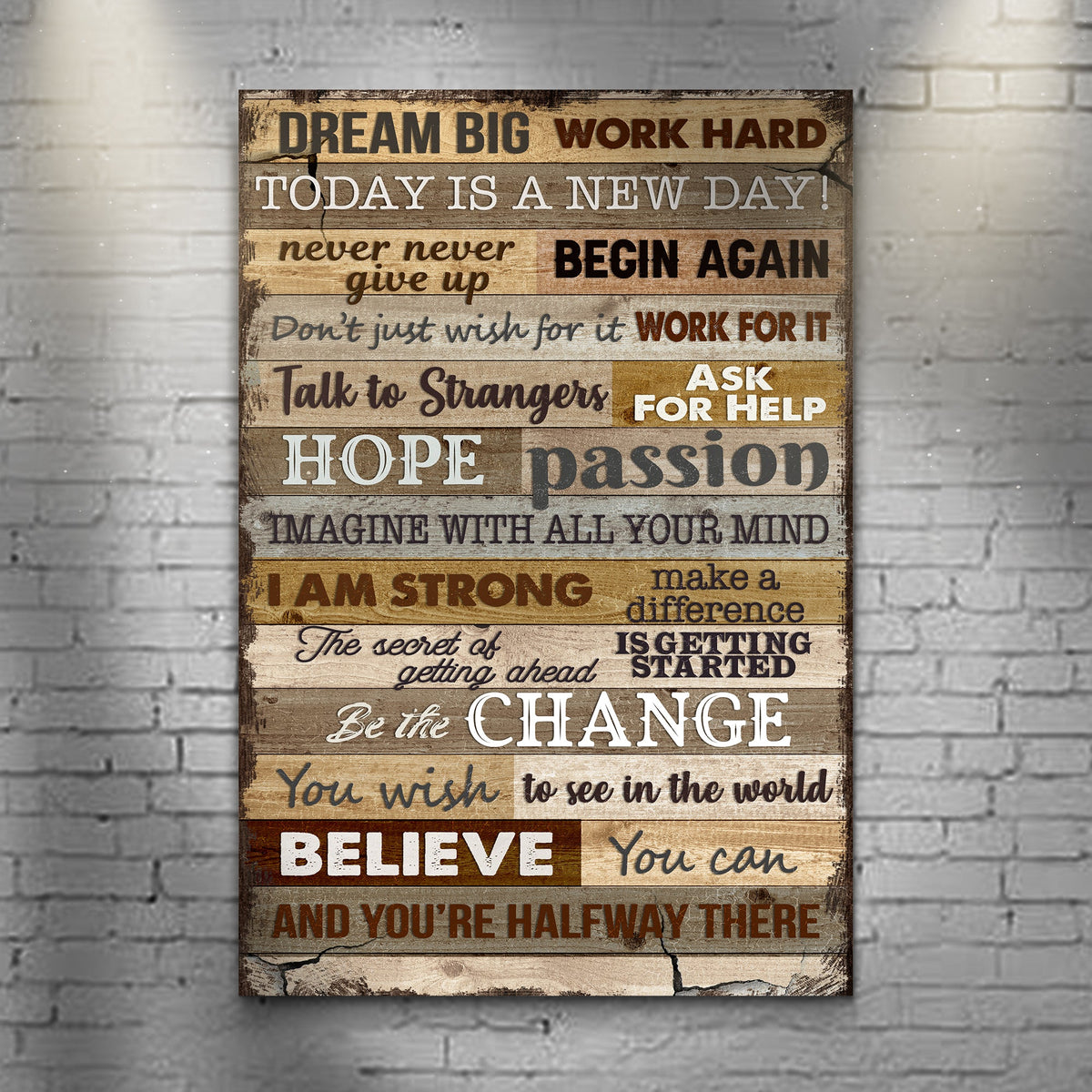 Motivational poster with inspirational quotes on a wooden panel against a brick wall.