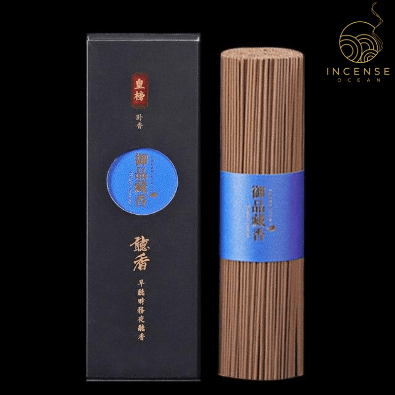 A bundle of incense sticks with a  blue label standing next to the incense box.